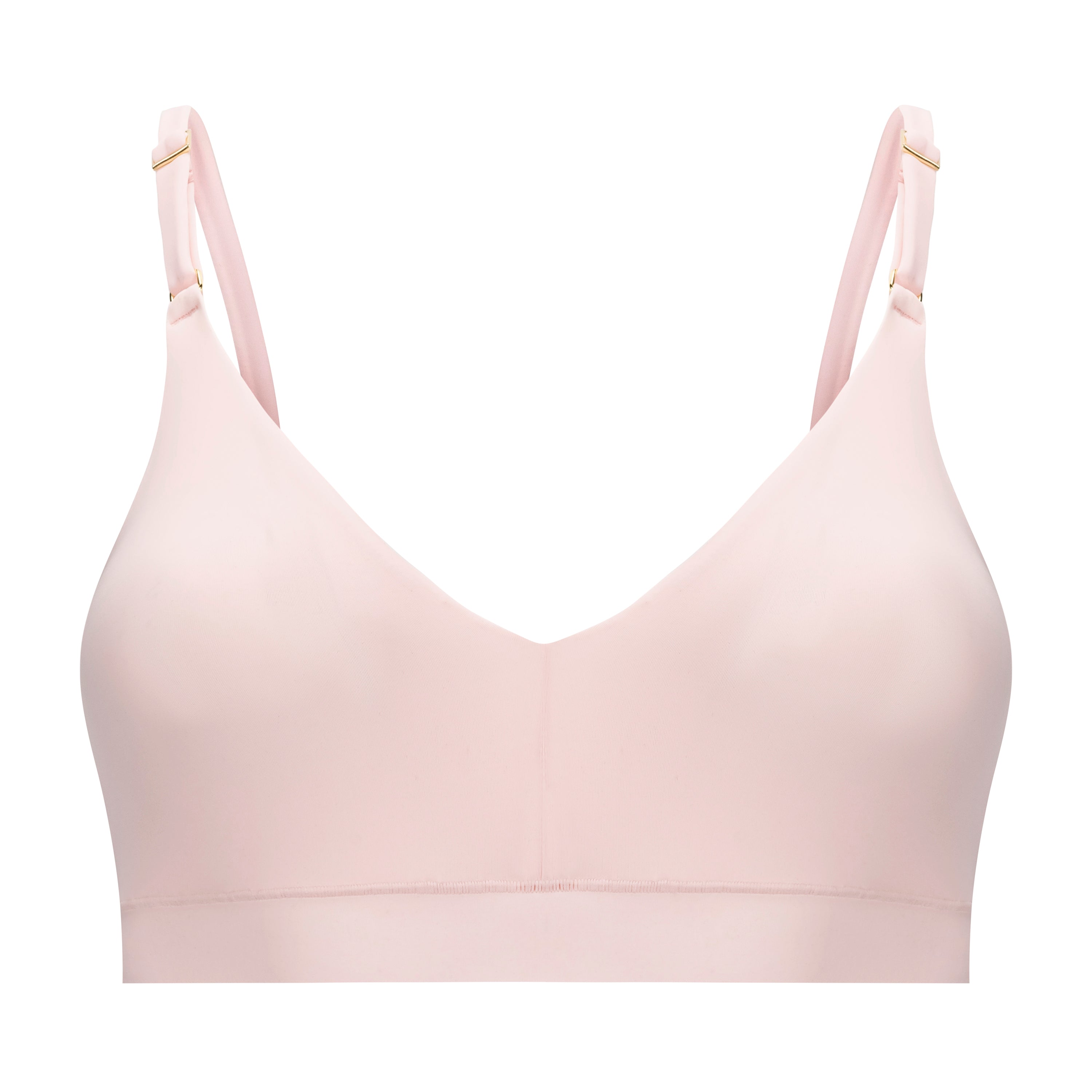 A rose quartz, underwire-free soft bra with adjustable straps and removable cup inserts on white background.
