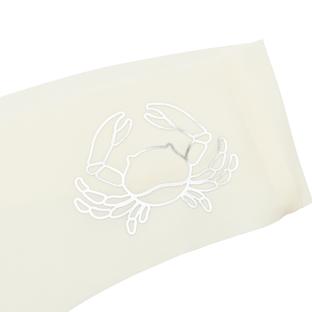 This image features a sleek white thong with a distinctive metallic silver decal of a zodiac sign on the waistband. The thong is designed with a cotton gusset for superior hygiene and is constructed with thermowelded side seams and removable tags for comfort.