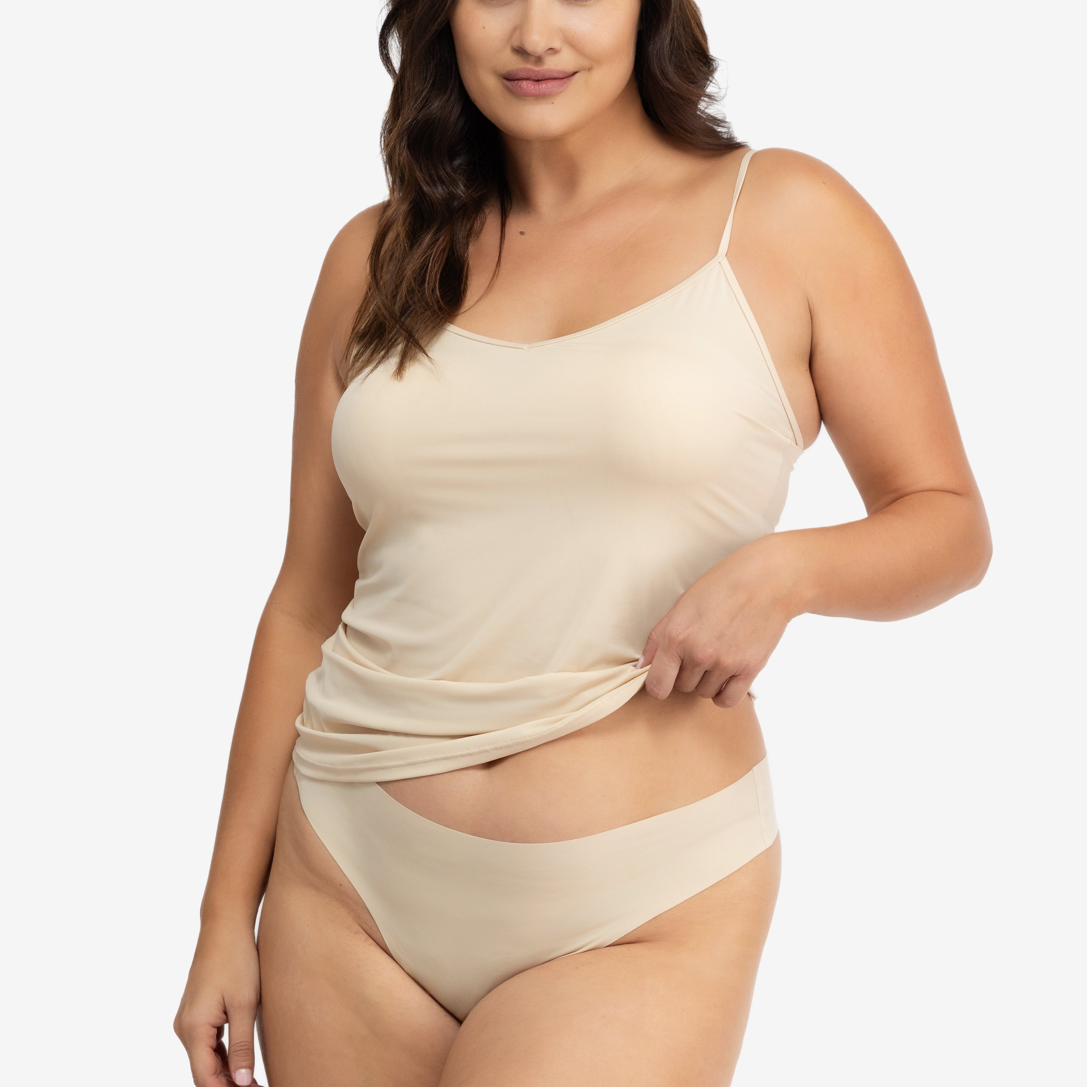 A woman wearing a smoke grey soft seamless thong underwear on white background.