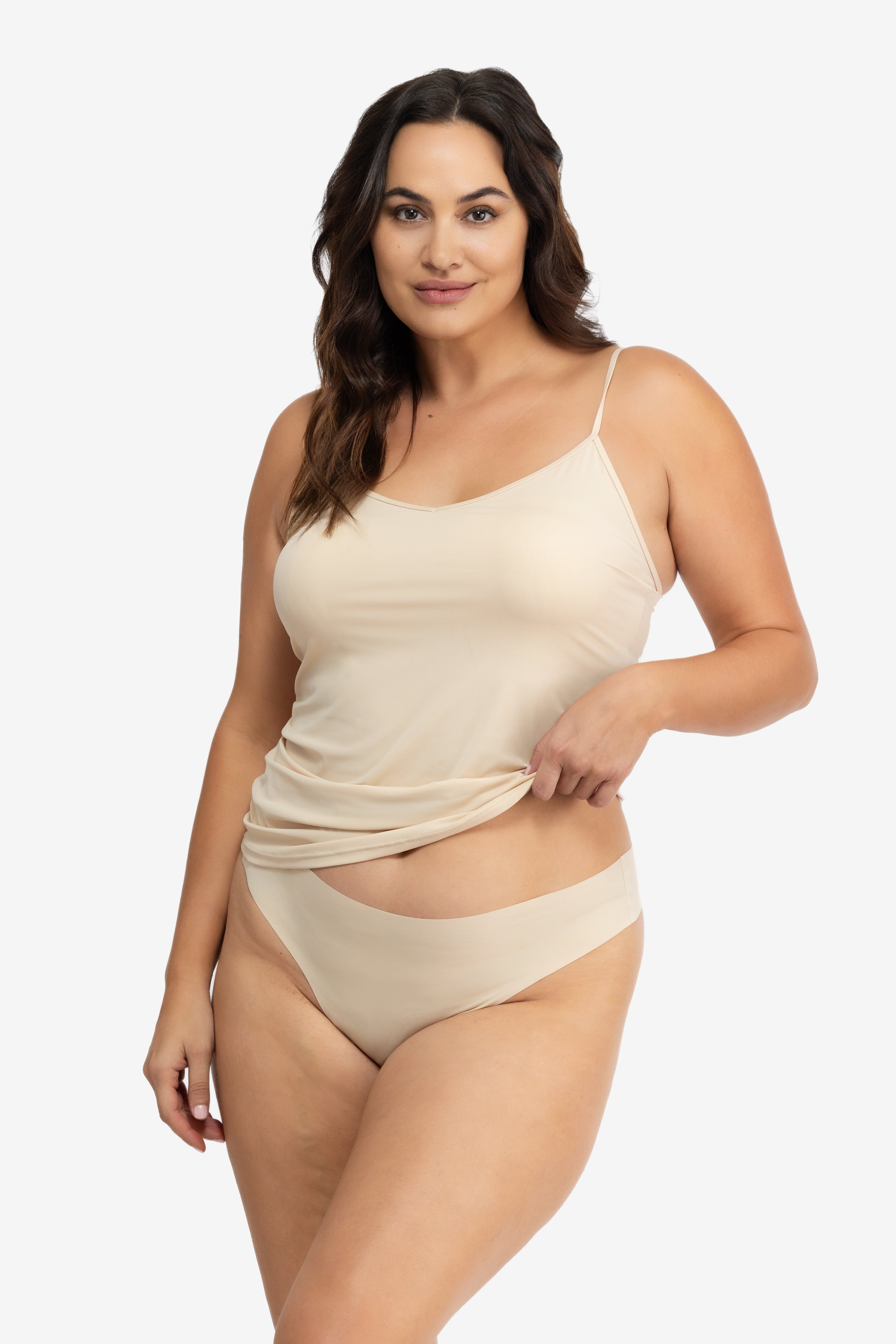 A woman wearing a smoke grey soft seamless thong underwear on white background.