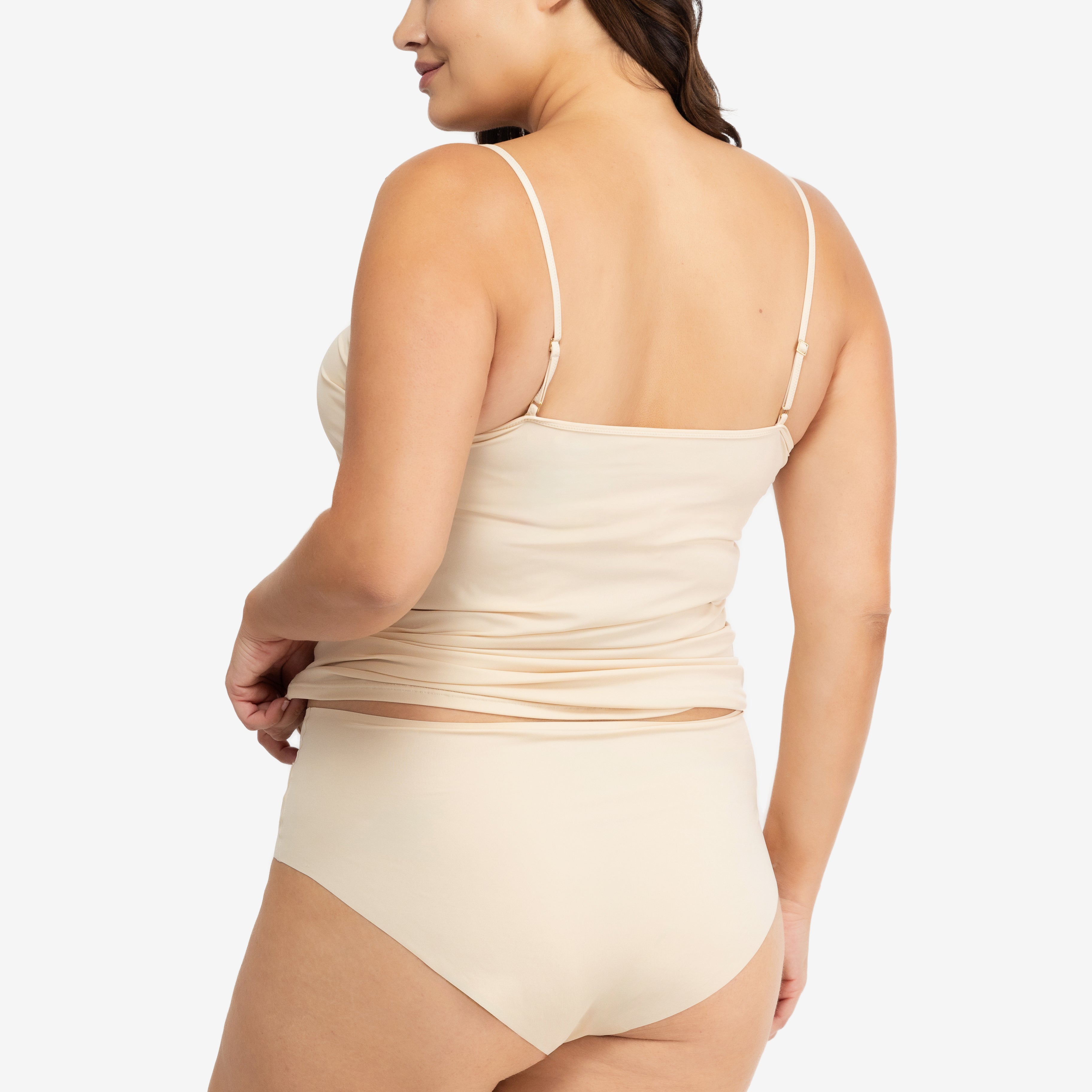 Woman wearing a Smoke Grey soft seamless camisole with adjustable spaghetti straps and a V-neckline on white background.