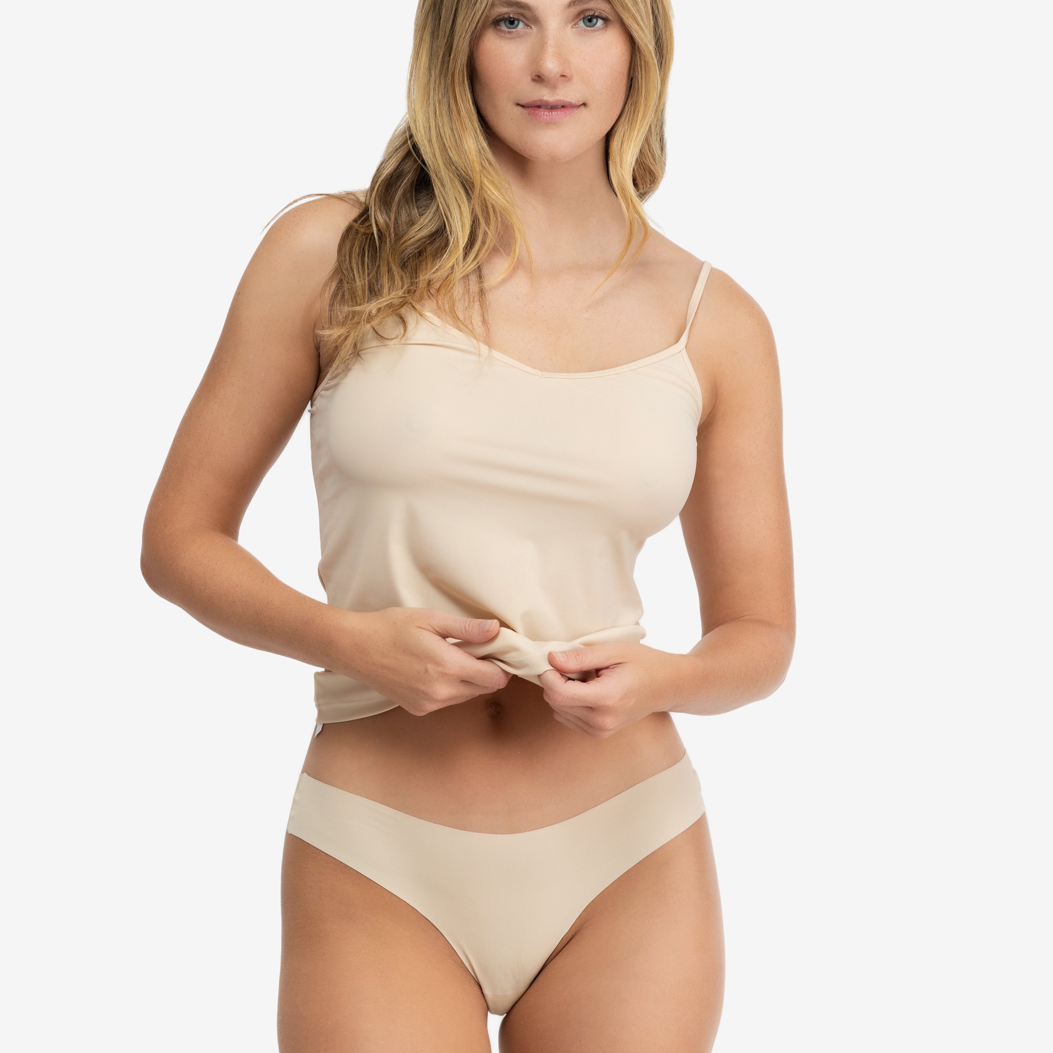 A woman wearing a smoke grey soft seamless thong underwear on white background.