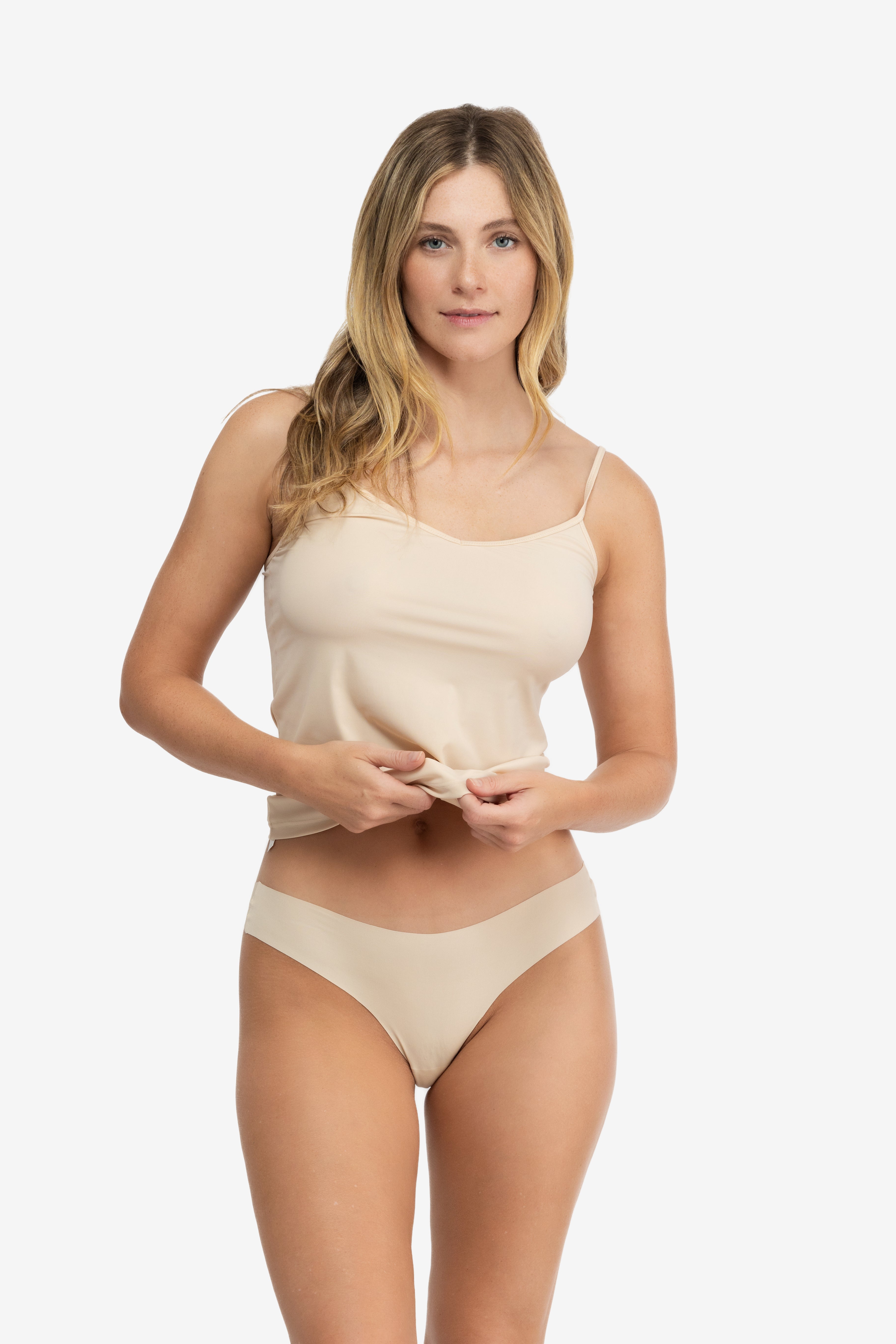 A woman wearing a smoke grey soft seamless thong underwear on white background.