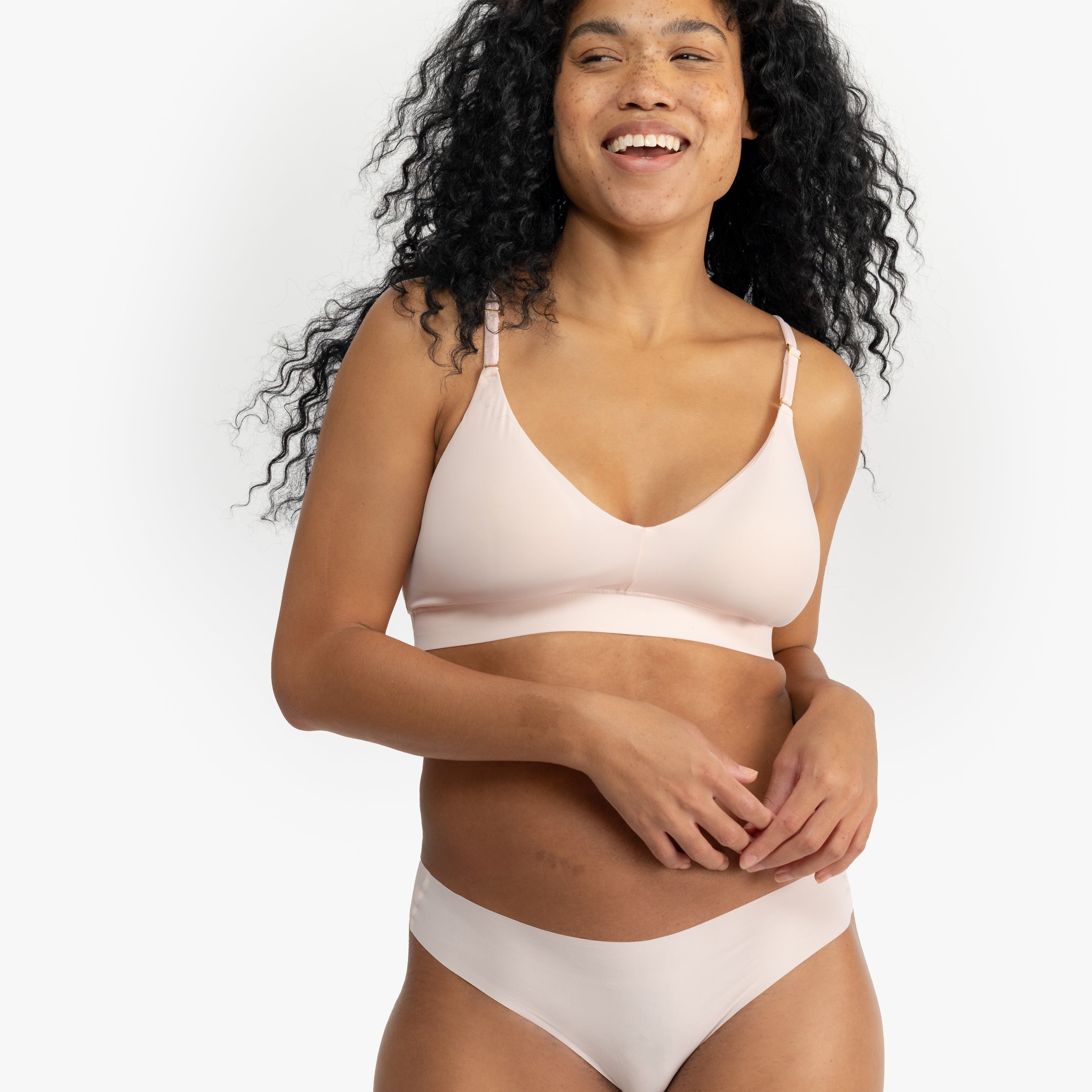 Model wearing Uwila Warrior Better Briefs Soft Bra in Rose Quartz on White Background