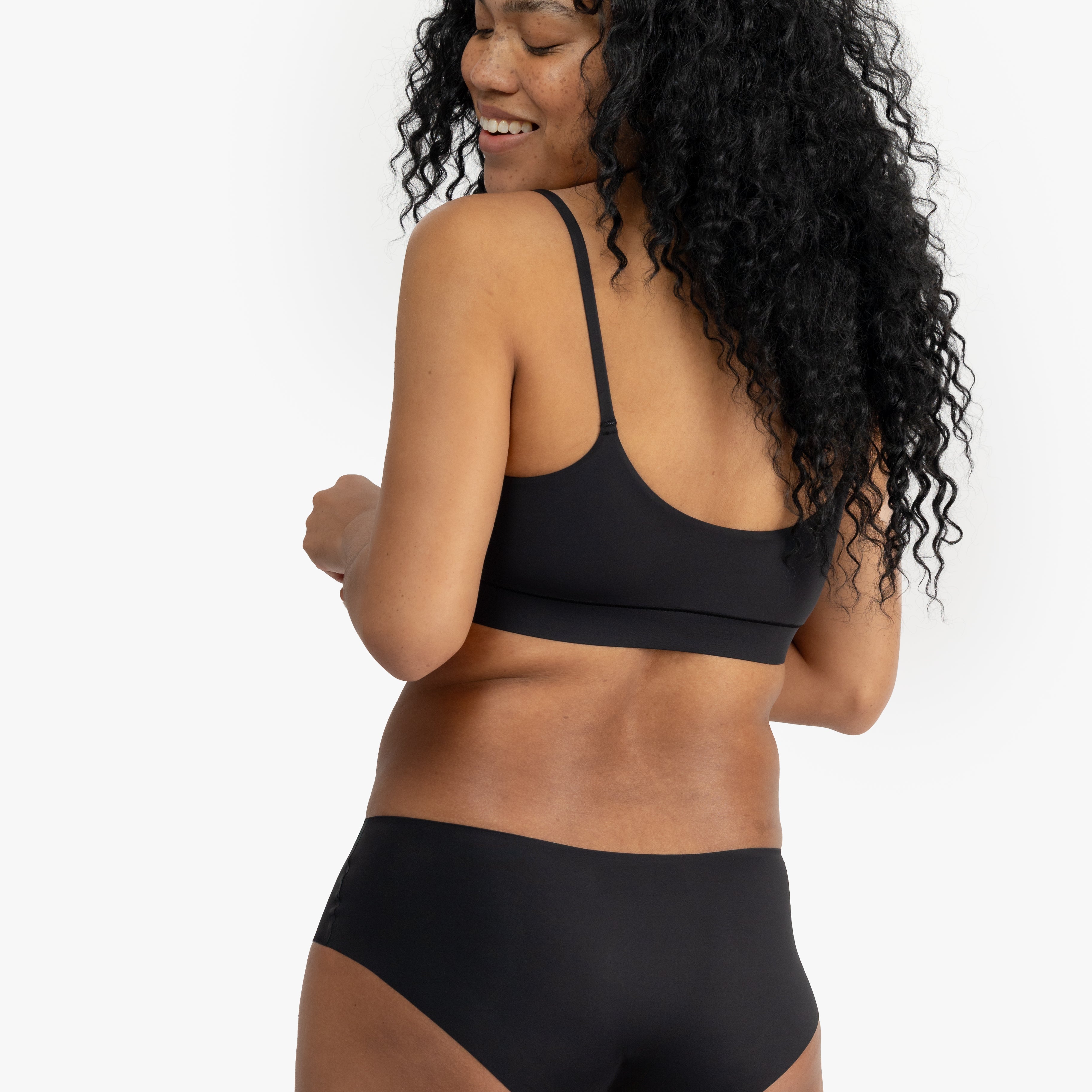 Model wearing Uwila Warrior Better Briefs Soft Bra in Tap Shoe Black on White Background
