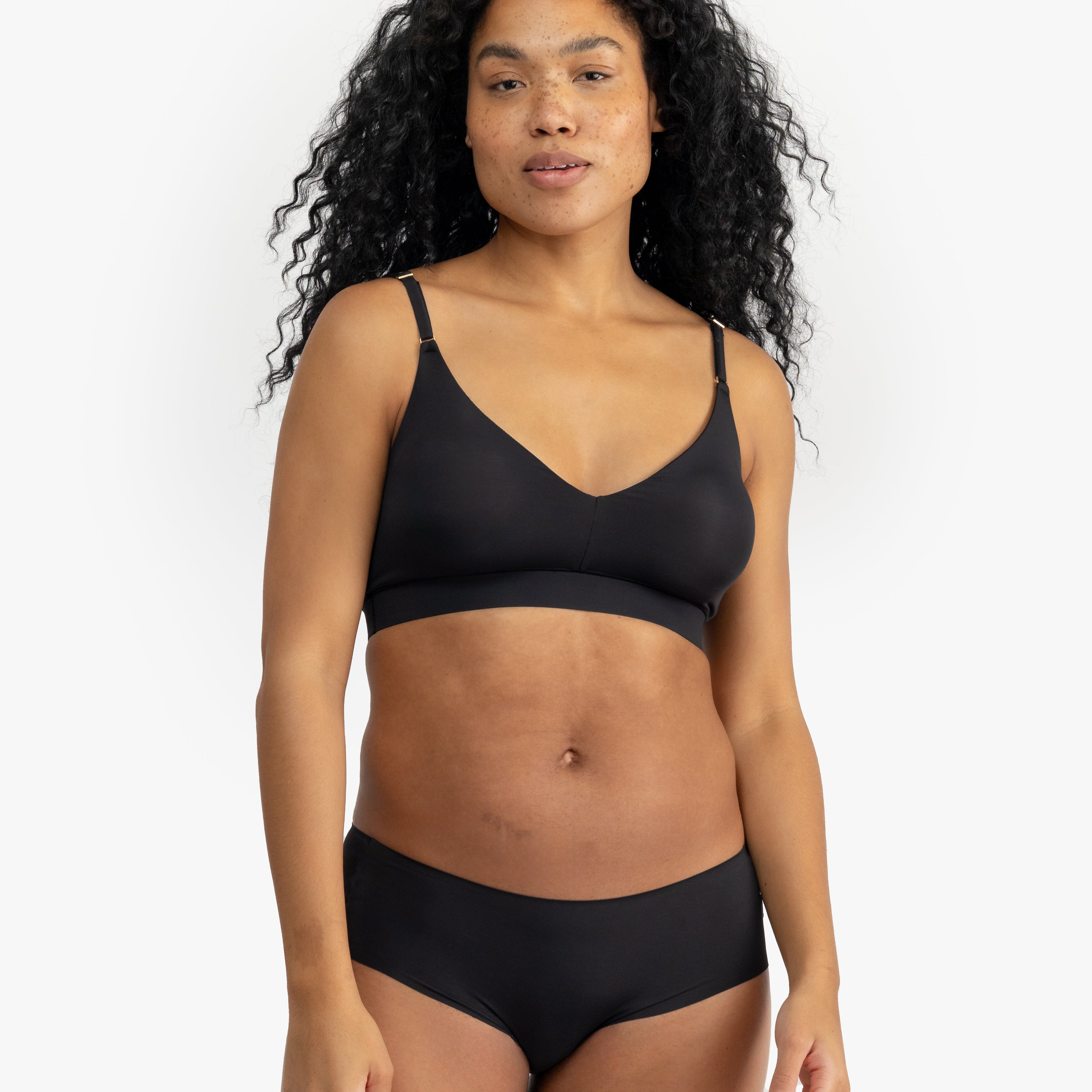 Model wearing Uwila Warrior Better Briefs Soft Bra in Tap Shoe Black on White Background