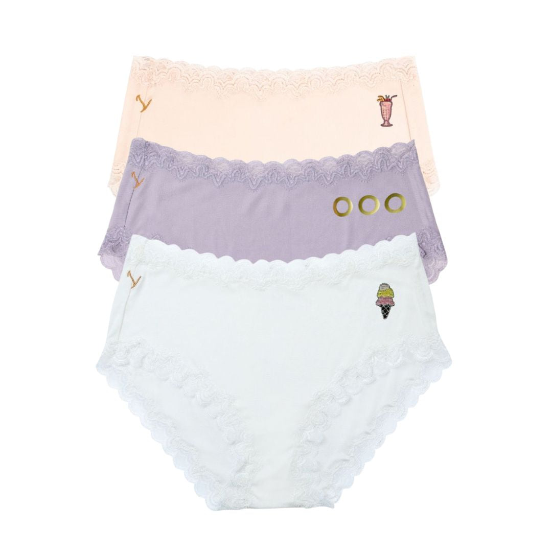 Uwila Warrior Soft Silk Briefs Getaway Bundle featuring Winter White with Ice Cream decal, Nirvana with OOO, and Rose Quartz with tropical drink decal on white background.