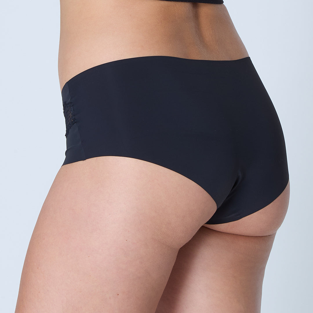 woman wearing Tap Shoe Black soft seamless briefs with lace on white background.