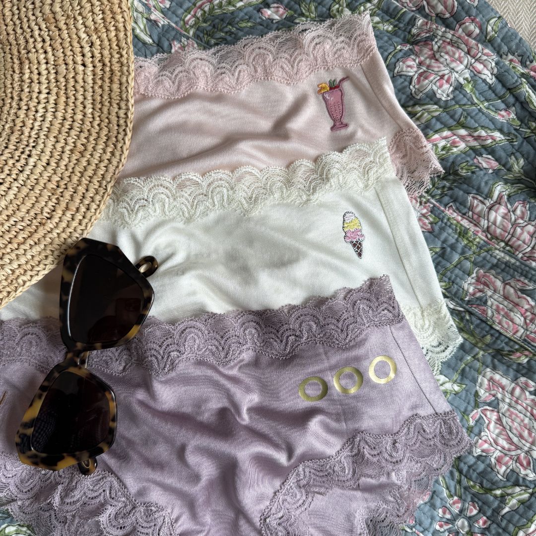 Uwila Warrior Getaway Bundle with sunglasses and hat on floral background.