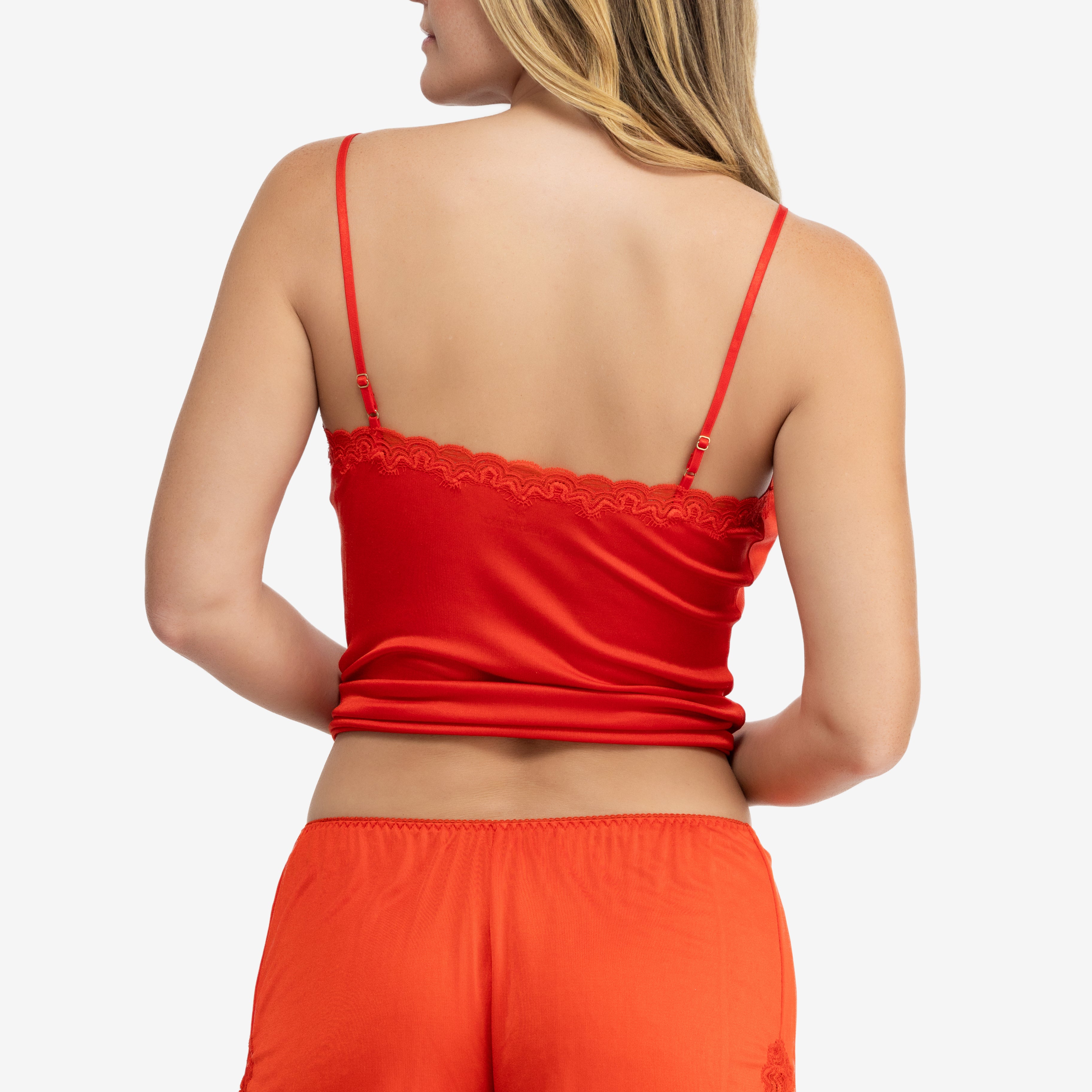 Model wearing Uwila Warrior Soft Silk Sleep Short in Fiery Red on White Background