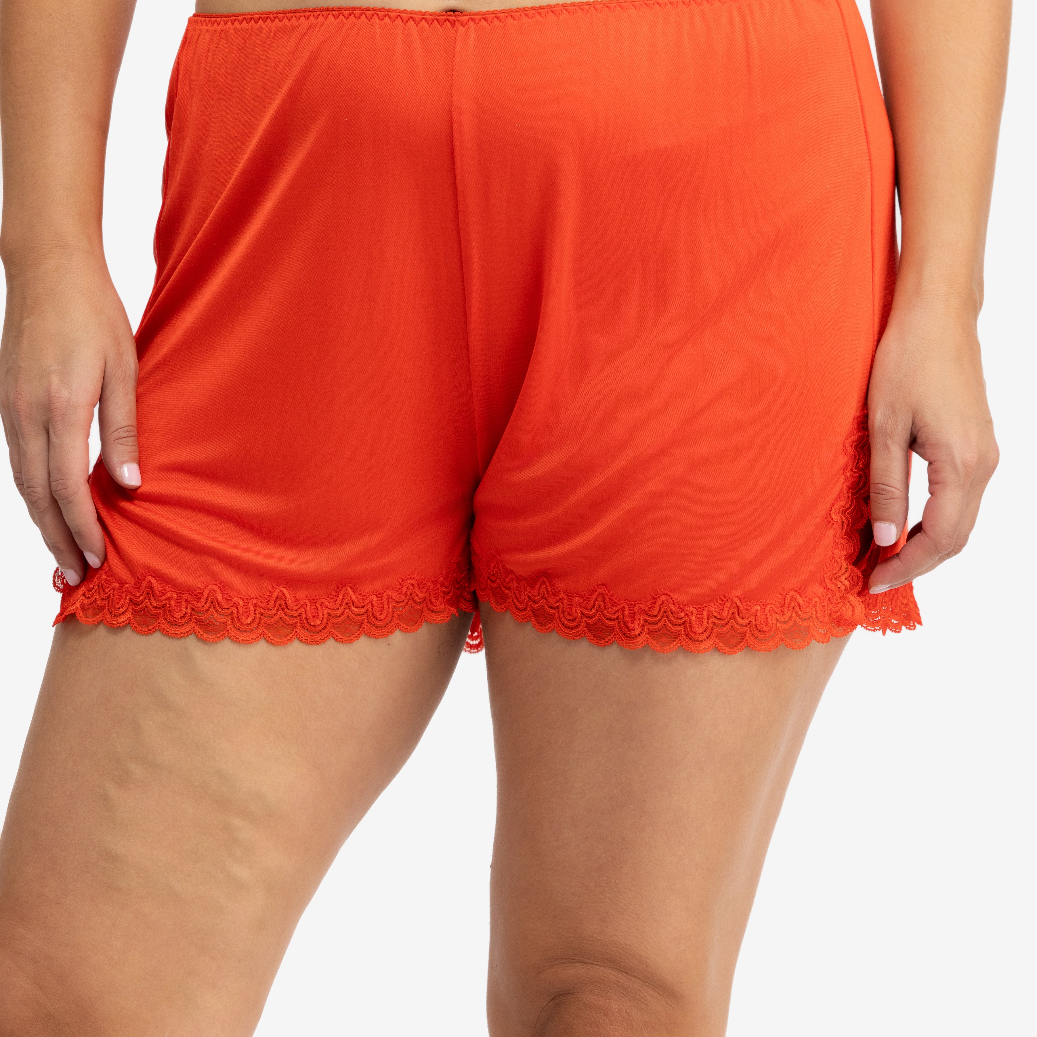 Model wearing Uwila Warrior Soft Silk Sleep Short in Fiery Red on White Background