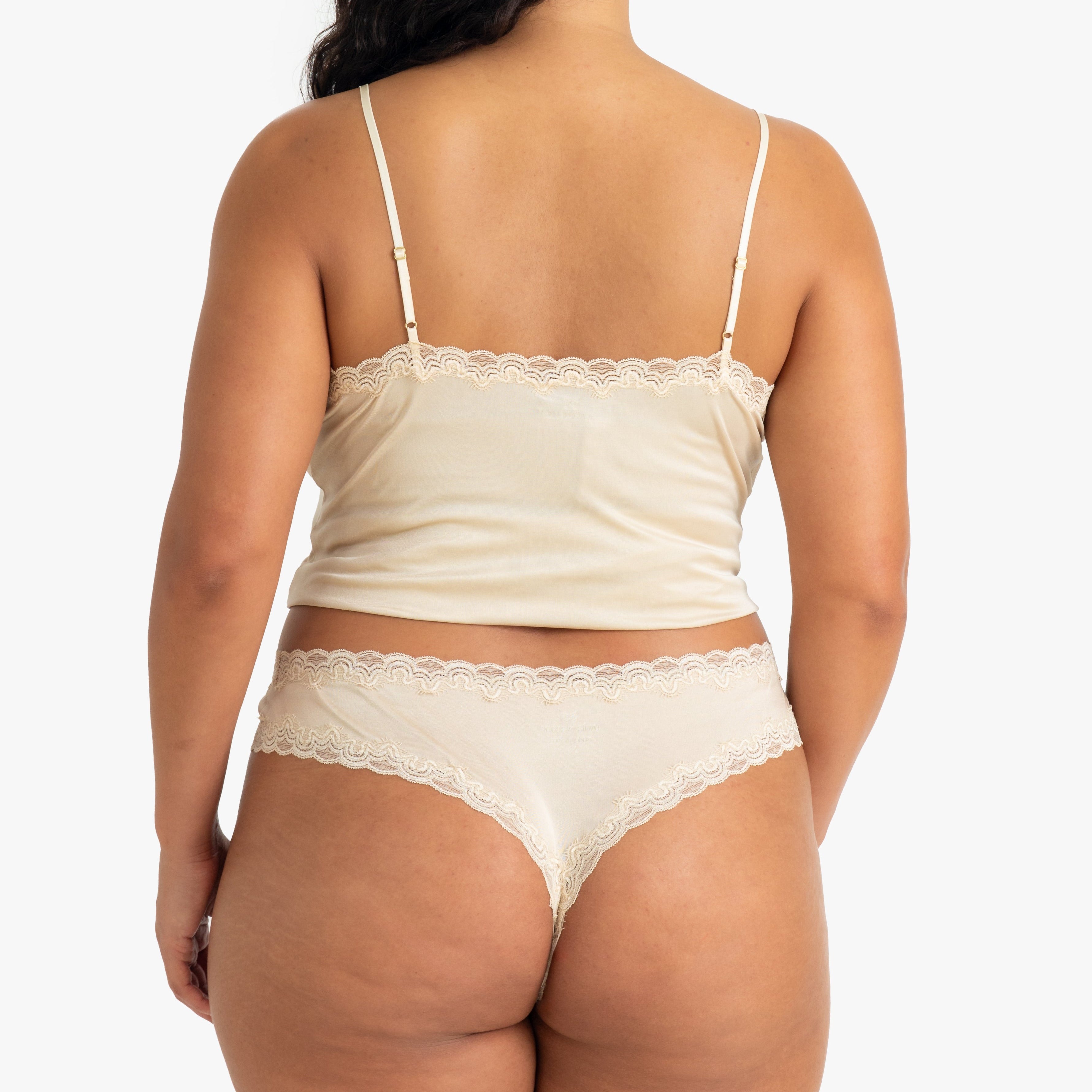 Model wearing Uwila Warrior Soft Silks Thong Underwear in Smoke Grey on White Background