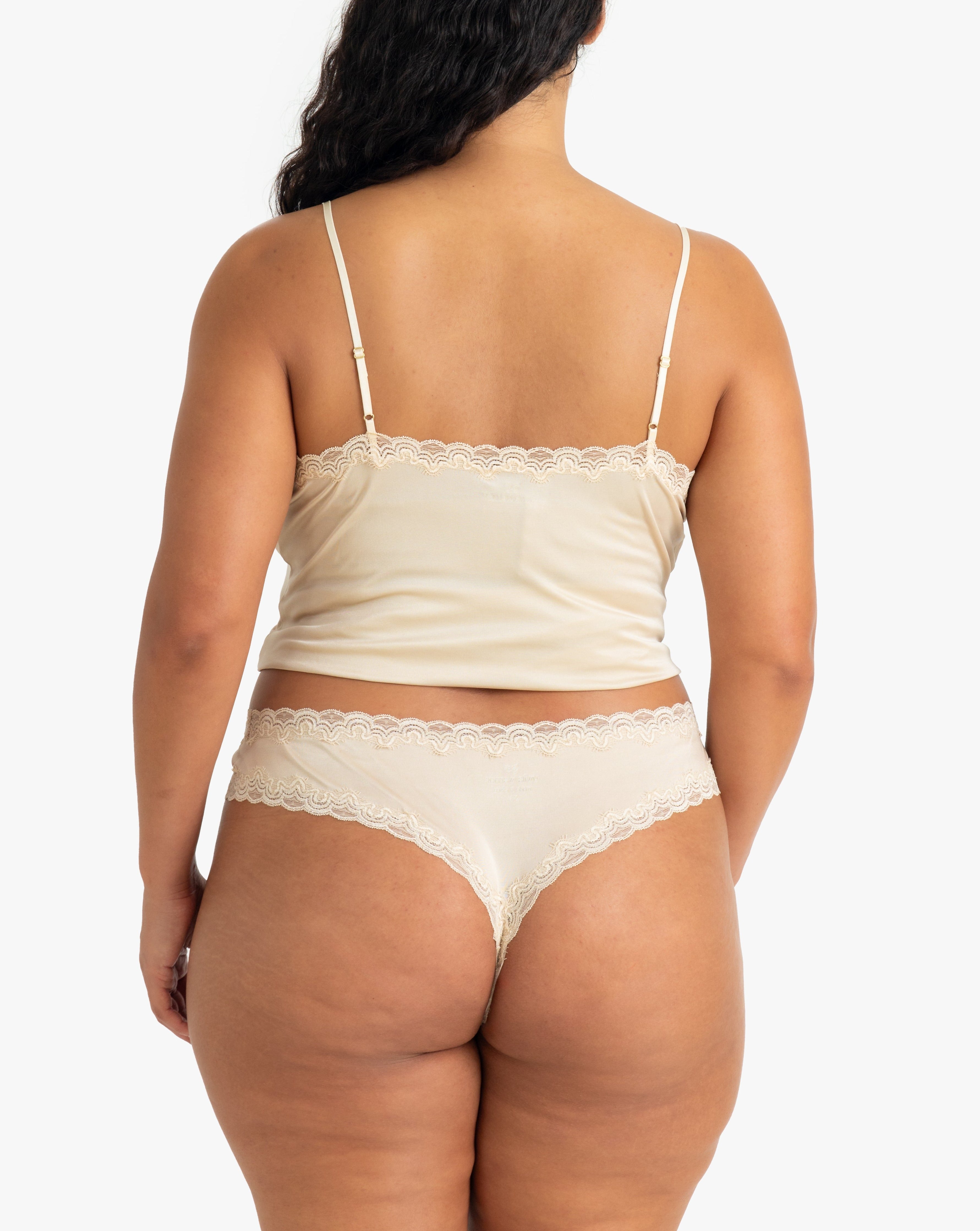 Model wearing Uwila Warrior Soft Silks Thong Underwear in Smoke Grey on White Background