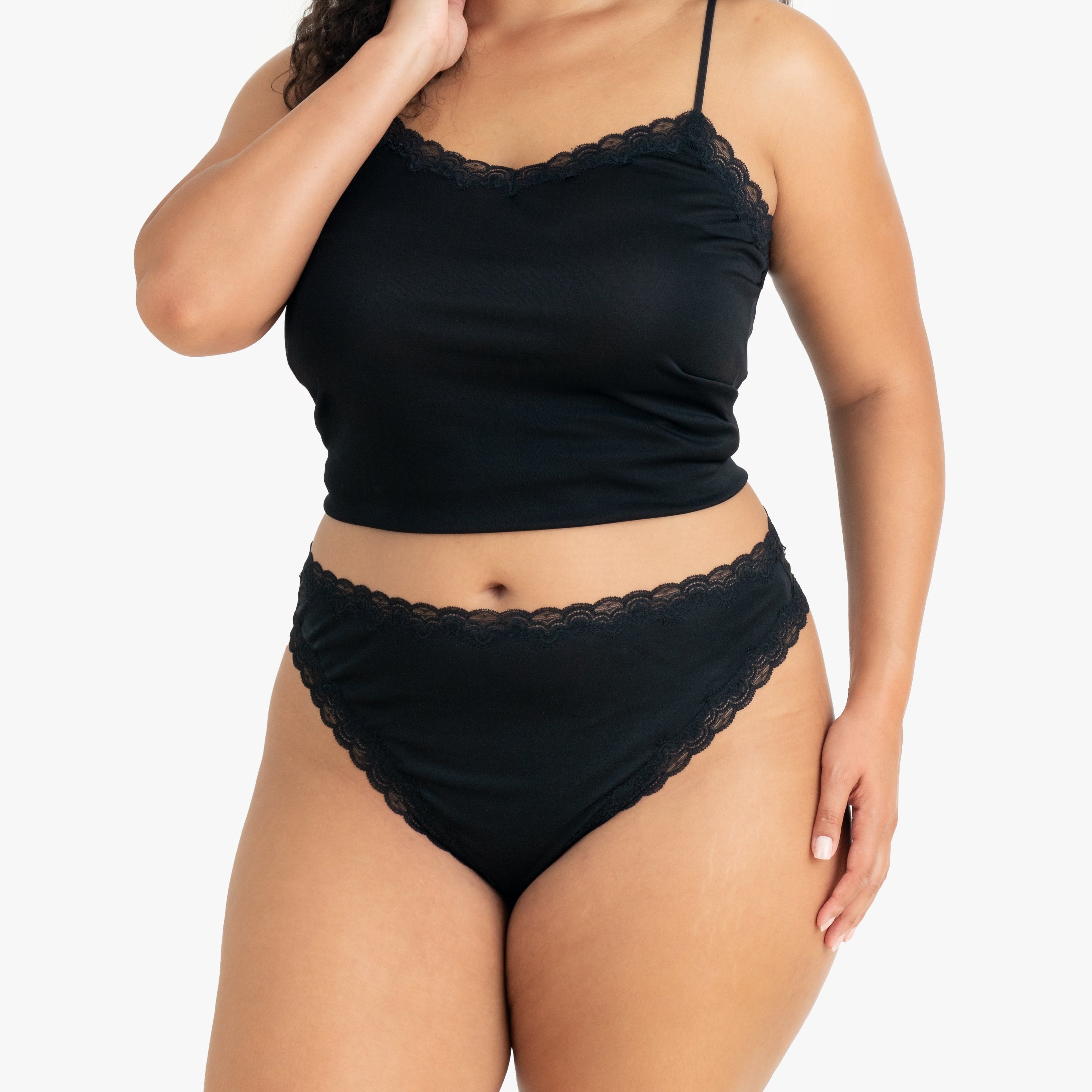Model wearing Uwila Warrior Soft Silks Thong Underwear in Tap Shoe Black on White Background