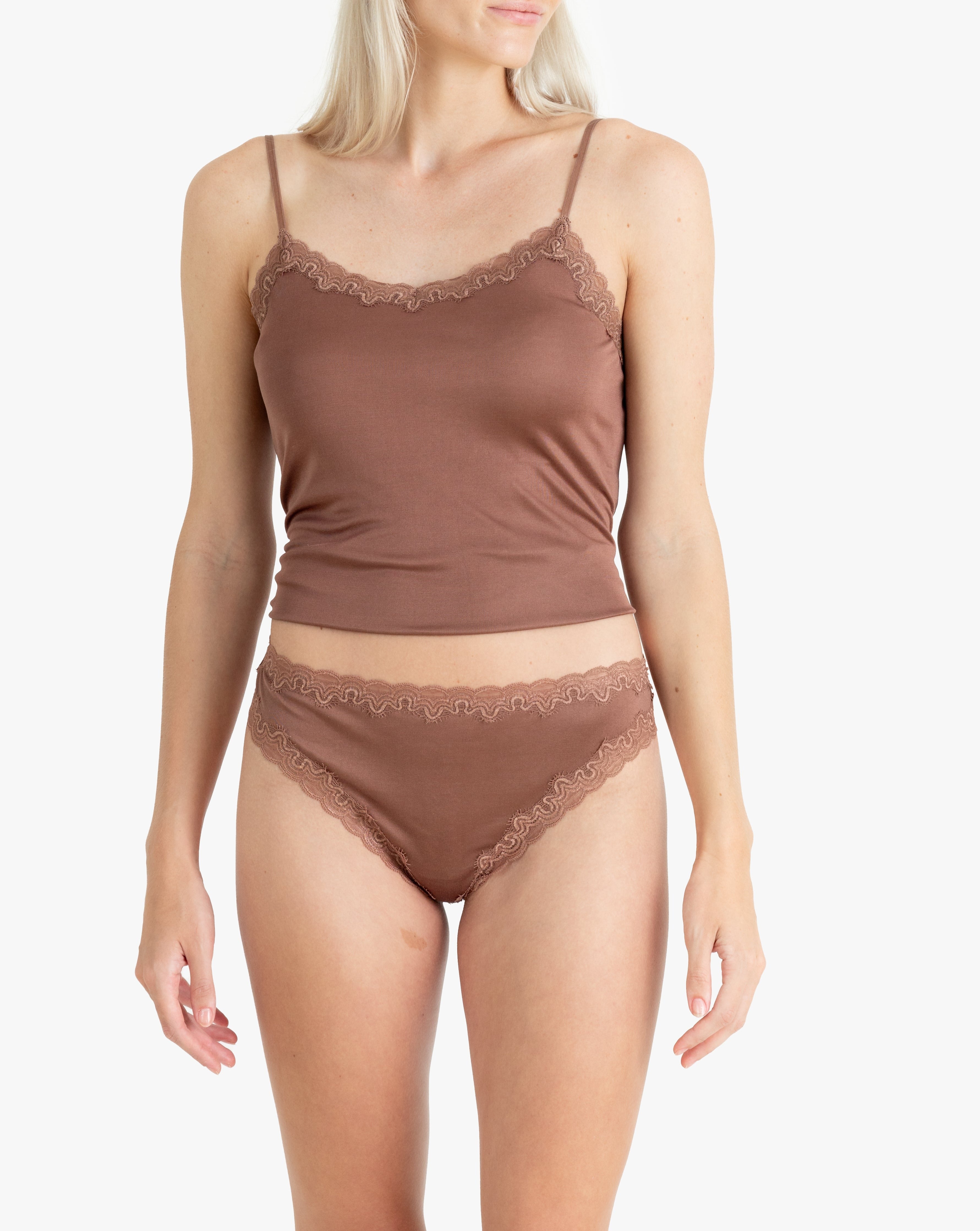 Model wearing Uwila Warrior Soft Silks Thong Underwear in Toffee on White Background