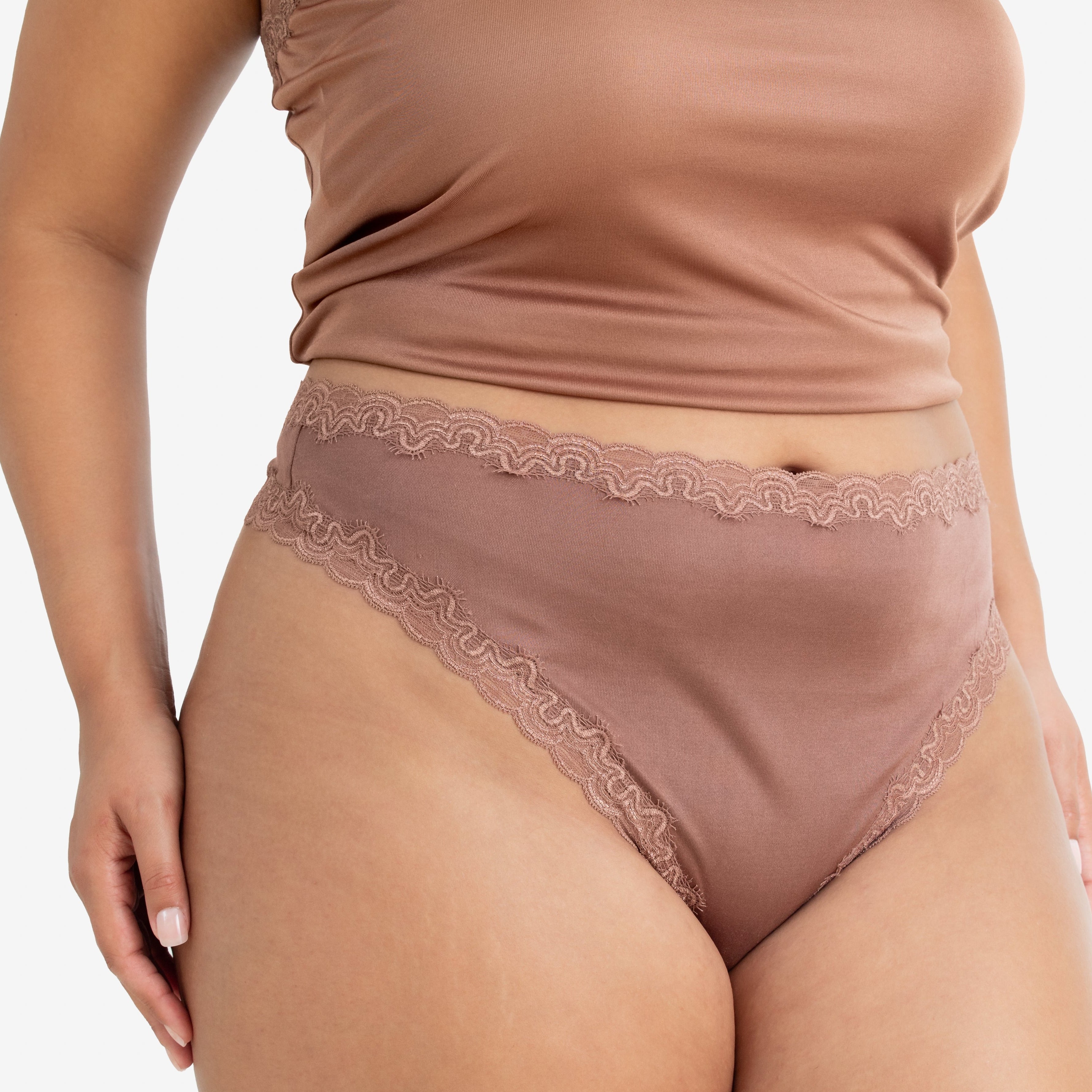 Model wearing Uwila Warrior Soft Silks Thong Underwear in Toffee on White Background