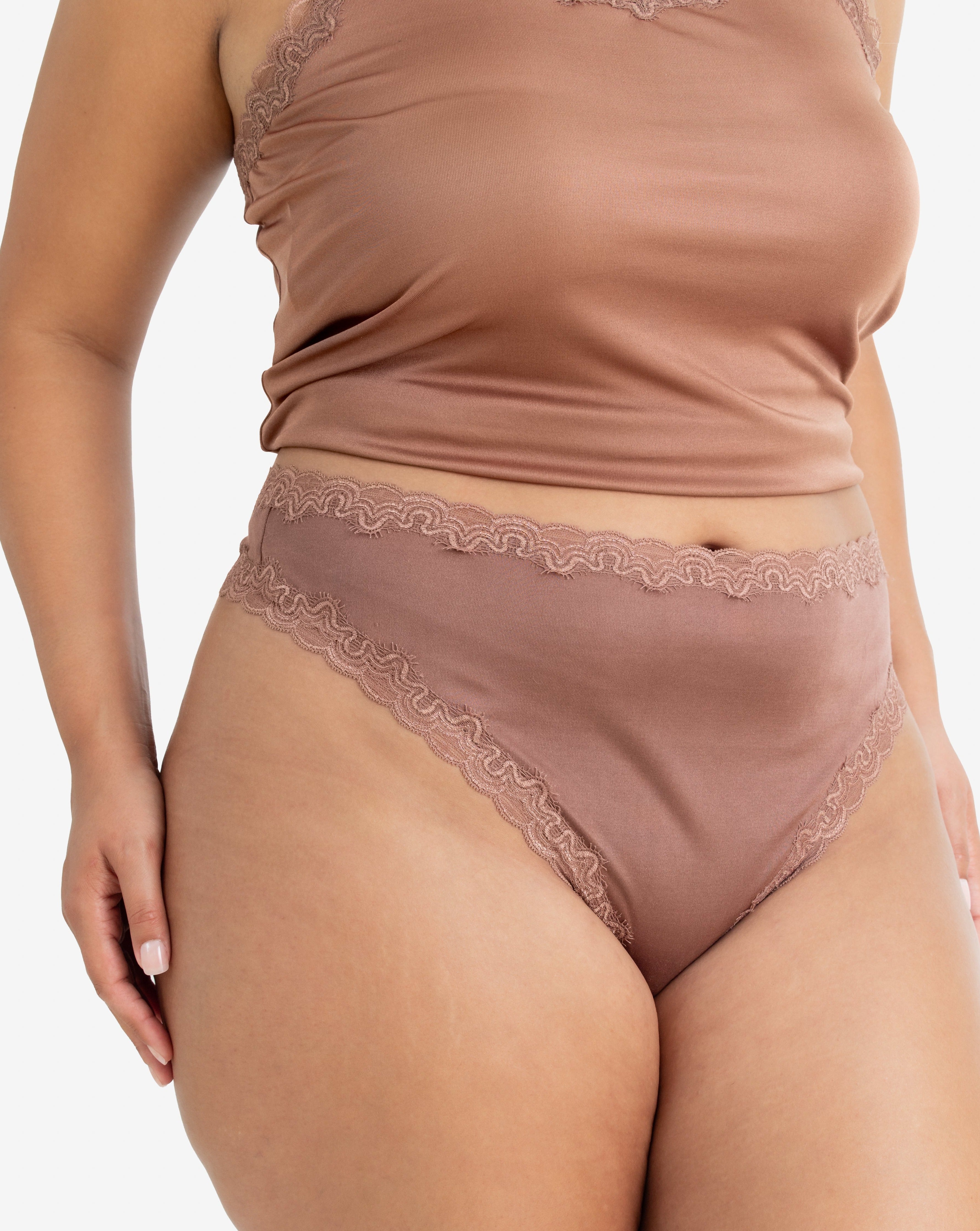 Model wearing Uwila Warrior Soft Silks Thong Underwear in Toffee on White Background