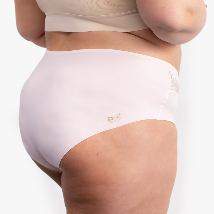 woman wearing rose quartz soft seamless briefs with lace
