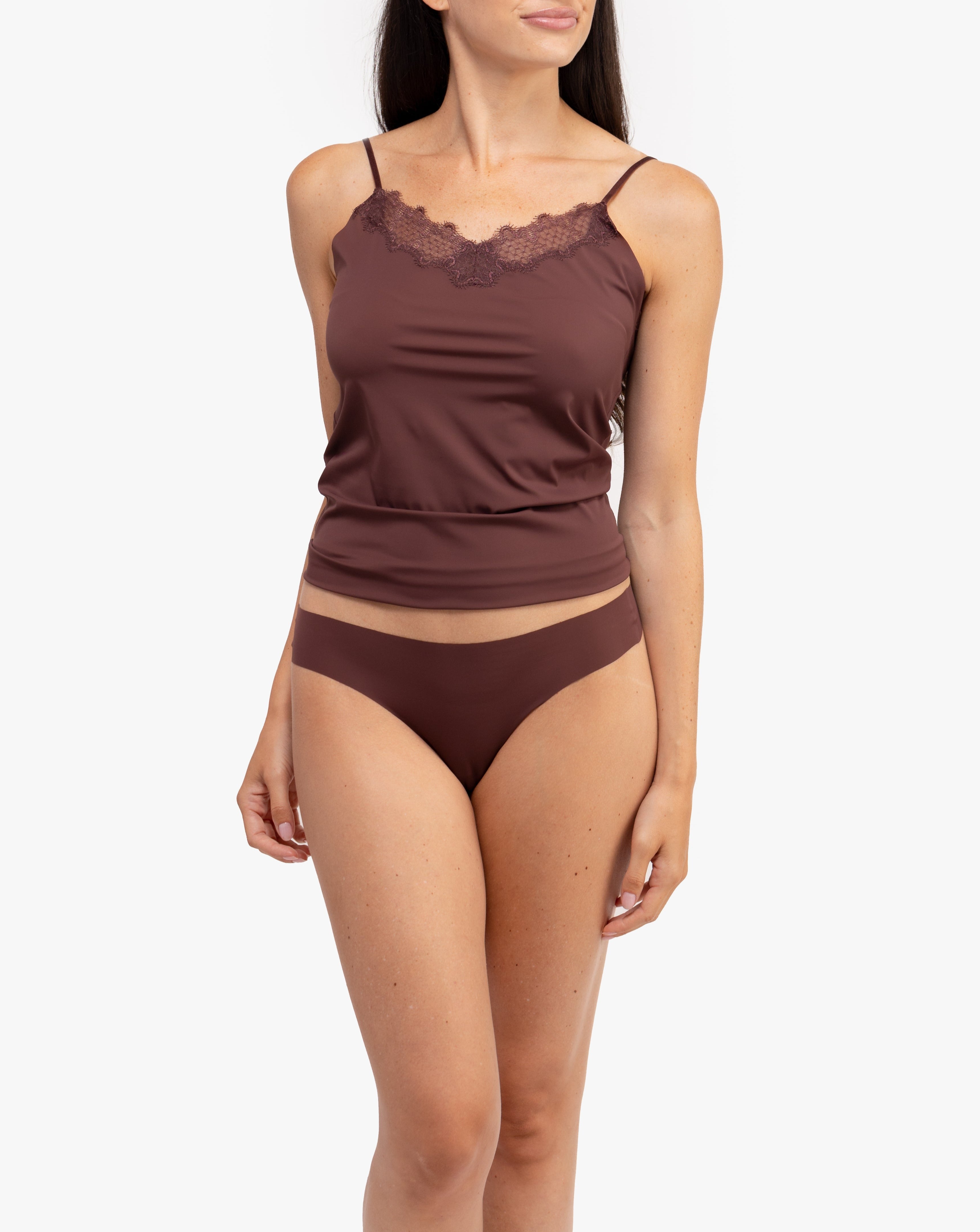 A woman wearing a chocolate soft seamless thong underwear on white background.
