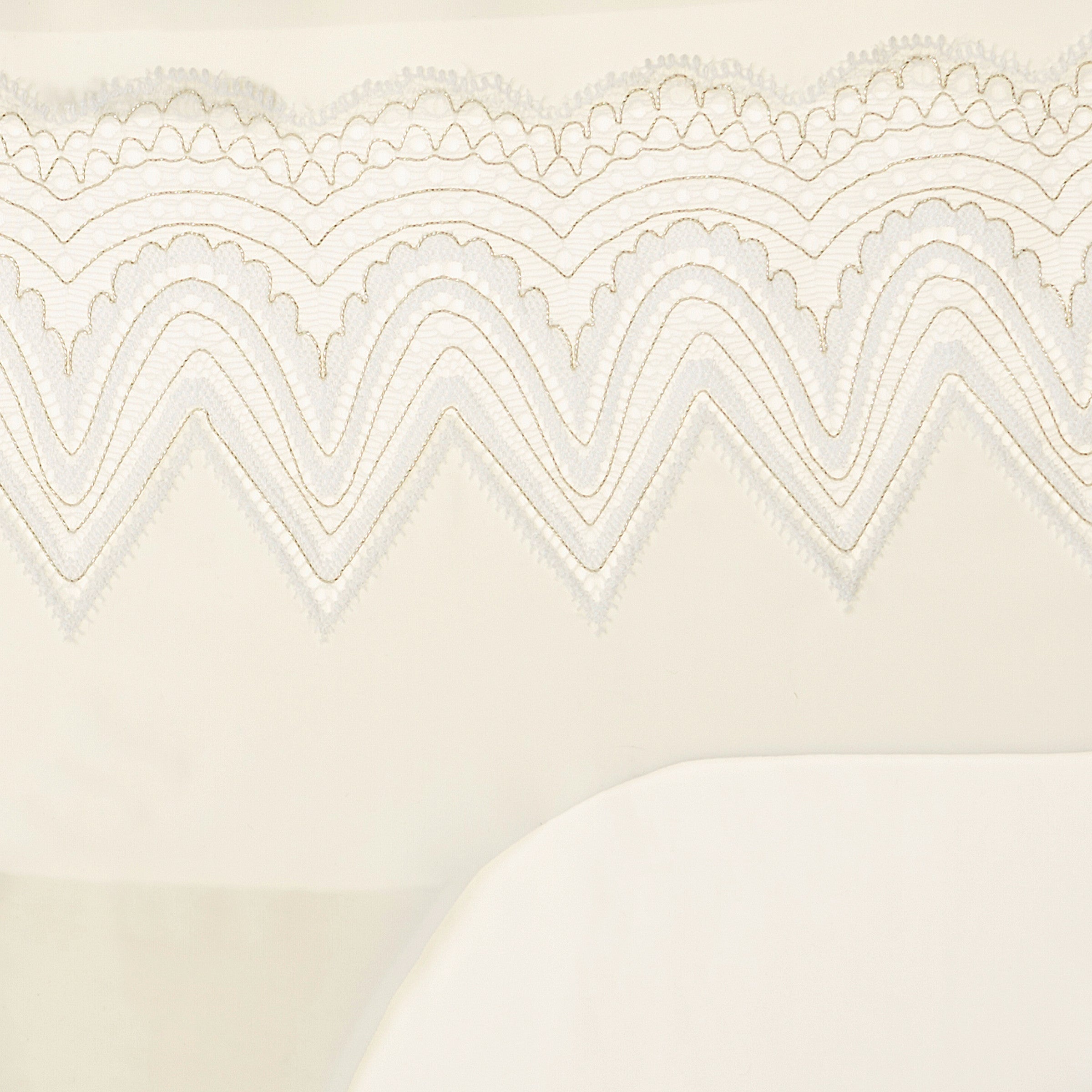 A pair of whisper white seamless bridal briefs with intricate lace detailing.