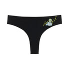 A soft seamless tap shoe black thong underwear with an embroidered floral pattern in contrasting colors against white background.