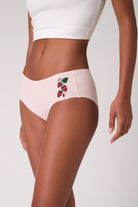 Model wearing Uwila Warrior Soft Seamless Rose Quartz Briefs with Wild Strawberry embroidery. 