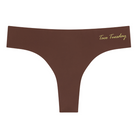 A chocolate soft seamless thong with 'Taco Tuesday' written in gold on the front.