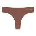 A toffee soft seamless thong with 'Hump Day' written in gold on the front.