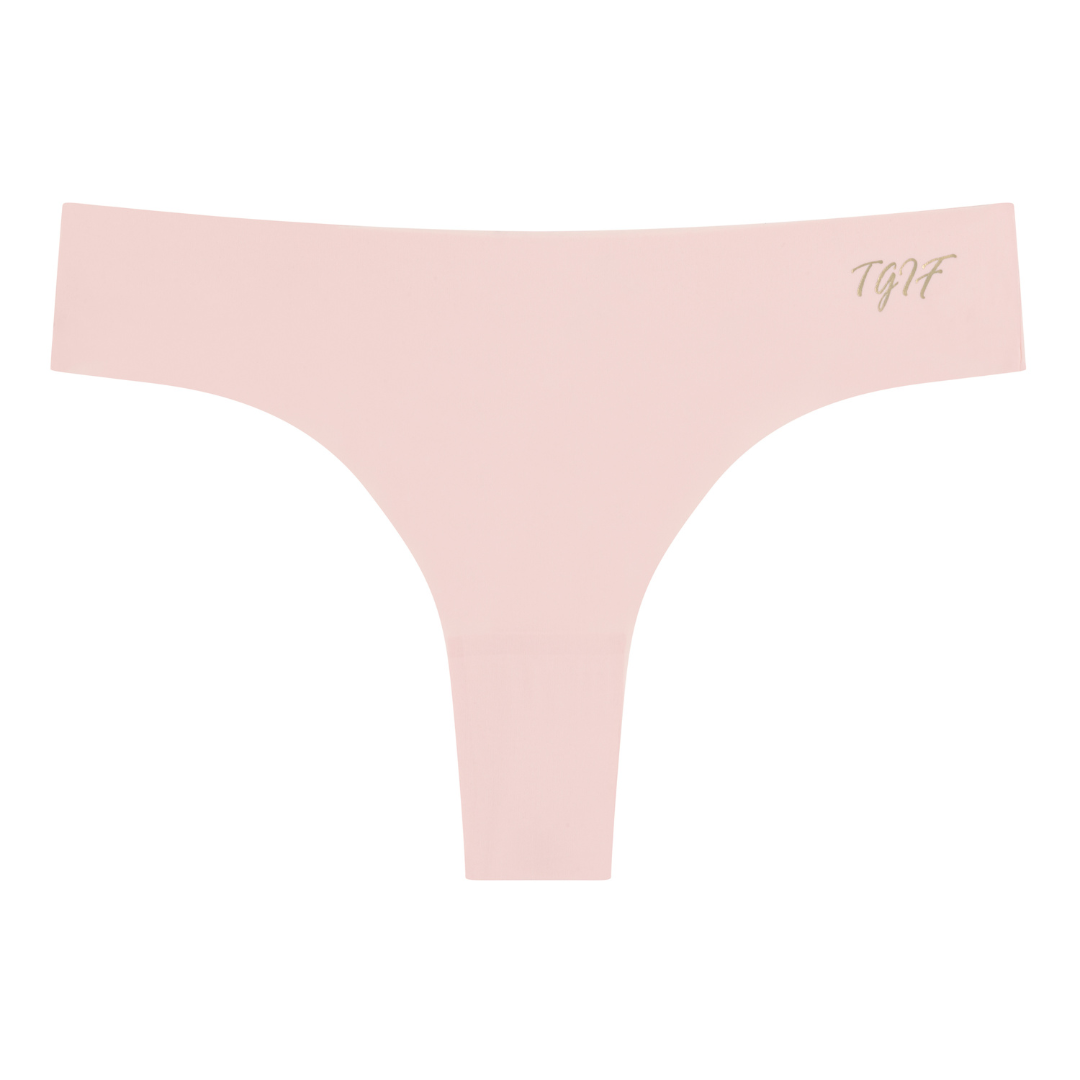 A rose qaurtz soft seamless thong with 'TGIF' written in gold on the front.