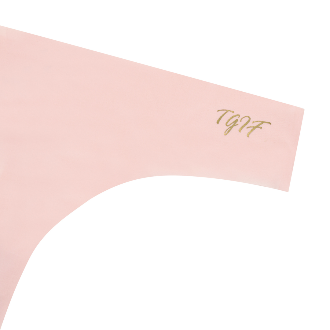 A rose qaurtz soft seamless thong with 'TGIF' written in gold on the front.