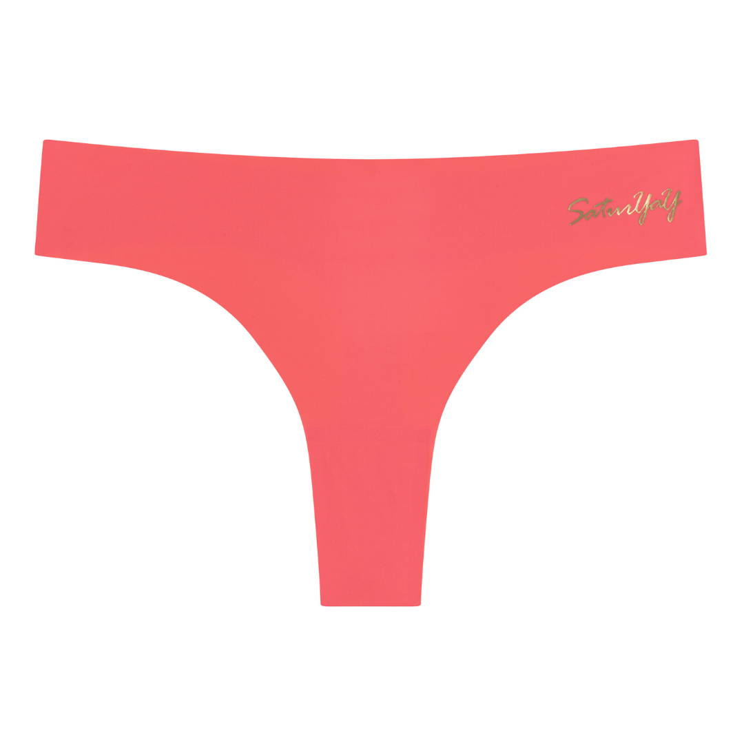 A Calypso Coral soft seamless thong with 'SaturYaY' written in gold on the front.