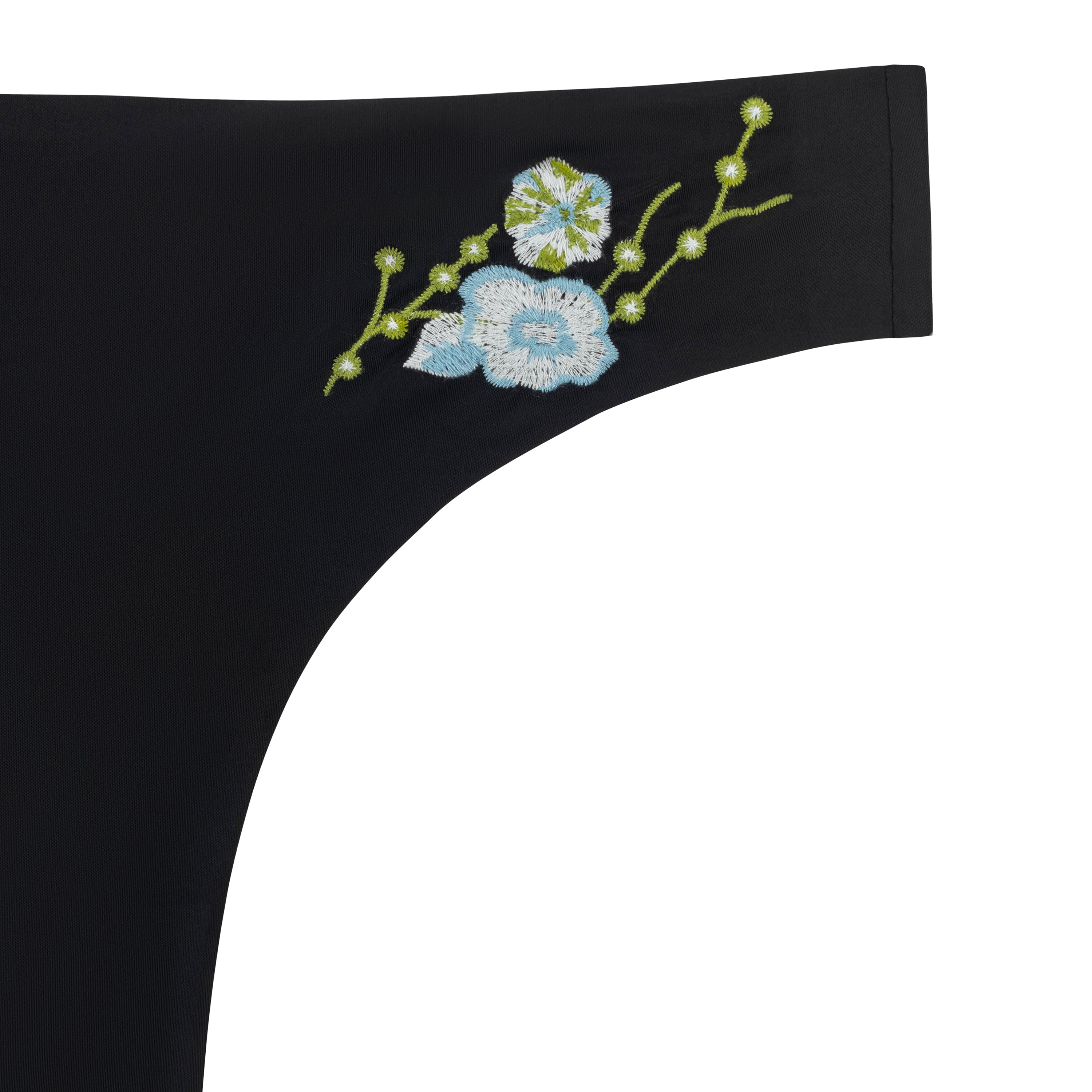 A soft seamless tap shoe black thong underwear with an embroidered floral pattern in contrasting colors against white background.