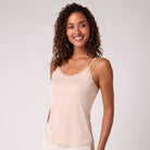 Model wearing smoke grey soft silk camisole on white background. 