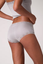 Model wearing Uwila Warrior Soft Silk Briefs in Alloy on a white background. 