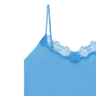 A light blue soft seamless camisole top with delicate lace detail at the neckline, with adjustable straps.