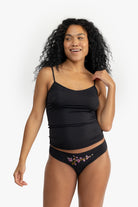 Woman wearing a Tap Shoe Black soft seamless camisole with adjustable spaghetti straps and a V-neckline on white background.