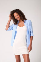 Model wearing a Uwila Warrior Soft Seamless slip in Winter White with blue over shirt. 