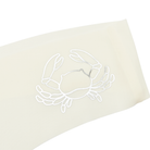 This image features a sleek white thong with a distinctive metallic silver decal of a zodiac sign on the waistband. The thong is designed with a cotton gusset for superior hygiene and is constructed with thermowelded side seams and removable tags for comfort.