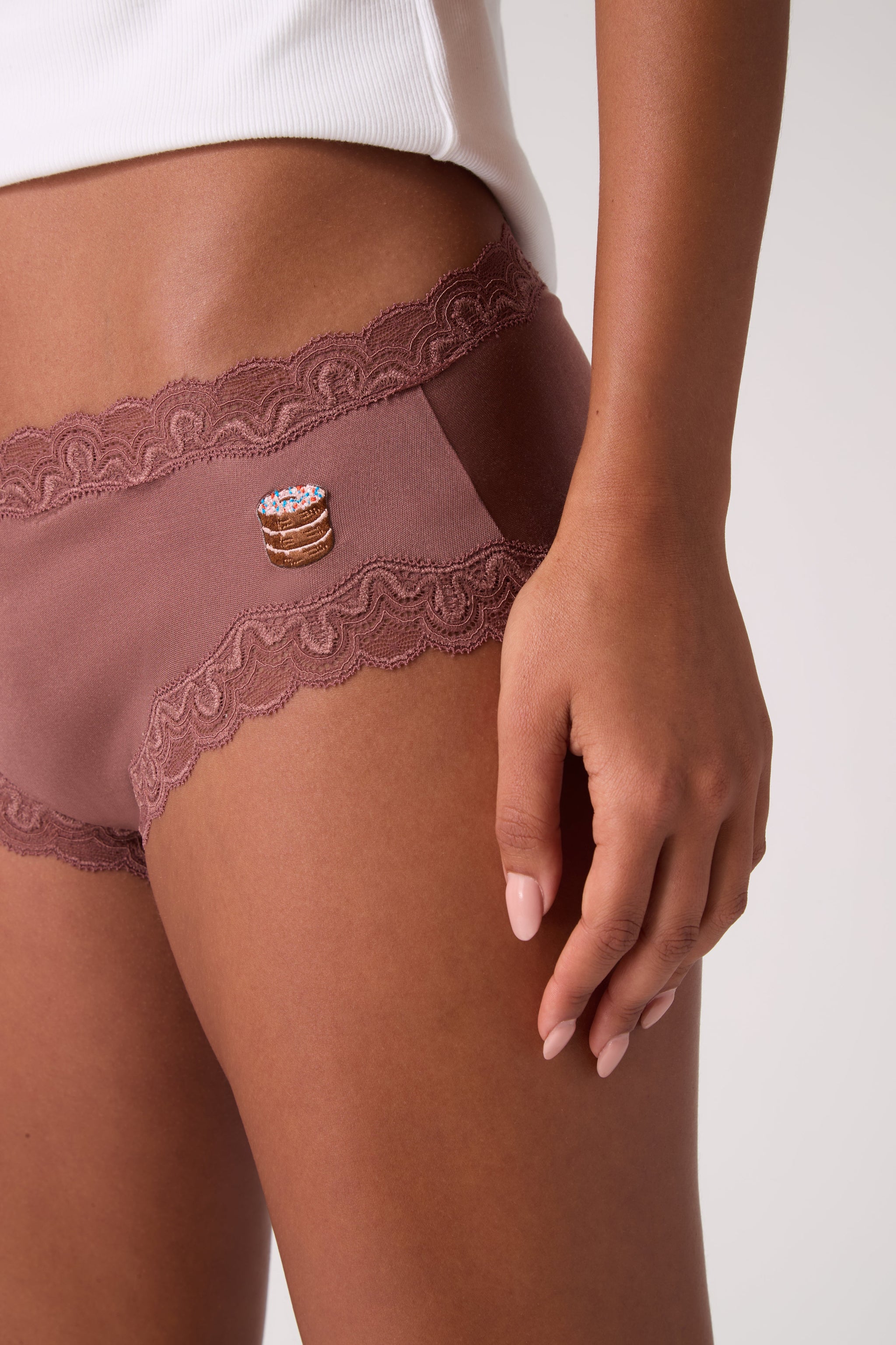 Model wearing Soft Silk Toffee Briefs with Donut Embroidery on white background