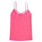 A pink soft seamless camisole with delicate lace detail at the neckline, with adjustable straps.