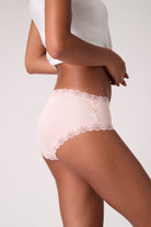 Model wearing Rose Quartz Soft Silk Briefs on white background.