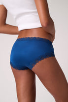 Back shot of Model wearing Soft Silk Briefs in Estate Blue on white background. 