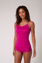 Woman wearing a Festival Fuchsia Soft Silk Camisole on a plain background