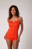 Model wearing Spicy Orange Soft Silk Camisole on White Background. 