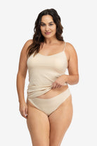 Woman wearing a Smoke Grey soft seamless camisole with adjustable spaghetti straps and a V-neckline on white background.