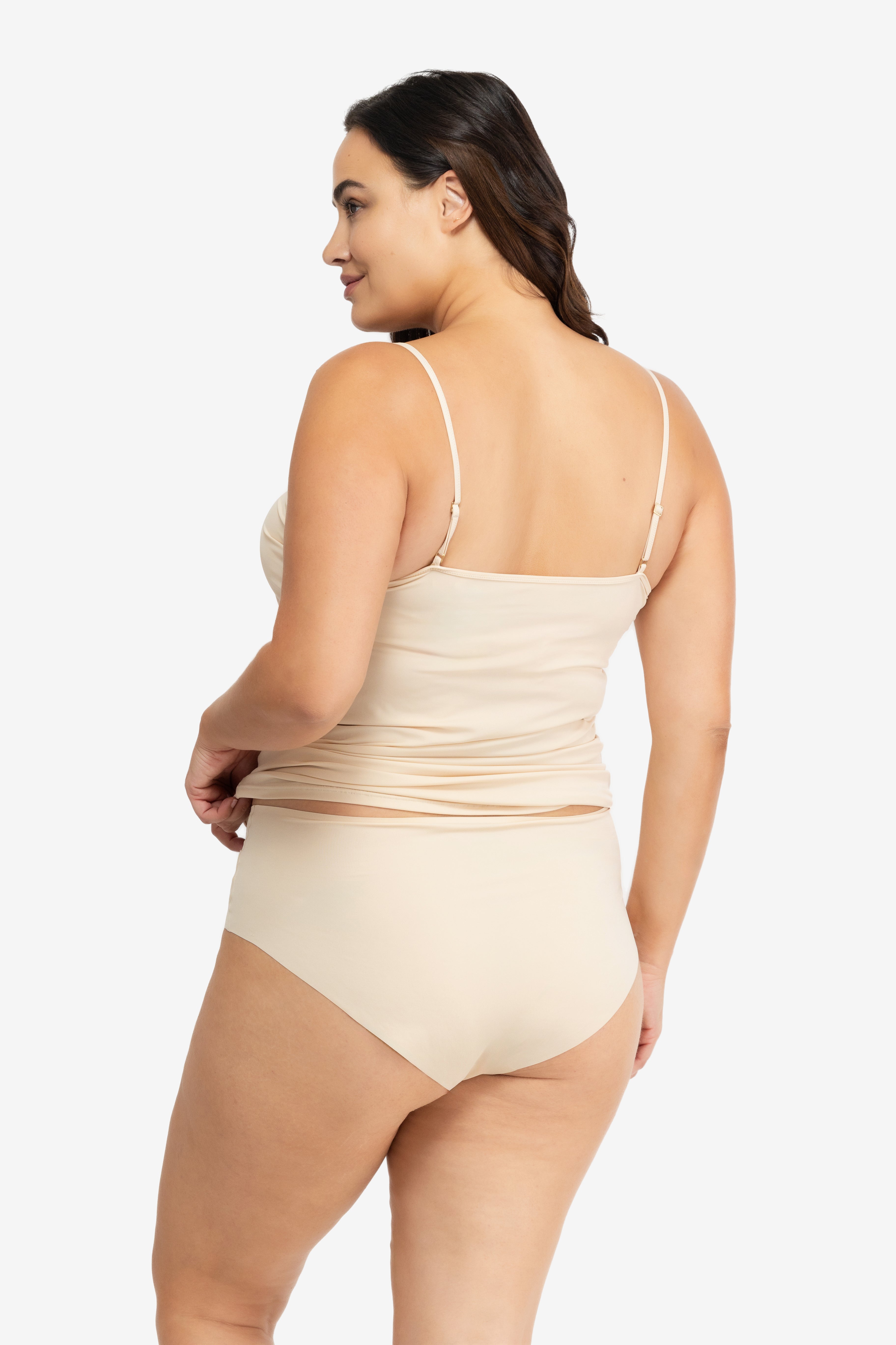 Woman wearing a Smoke Grey soft seamless camisole with adjustable spaghetti straps and a V-neckline on white background.