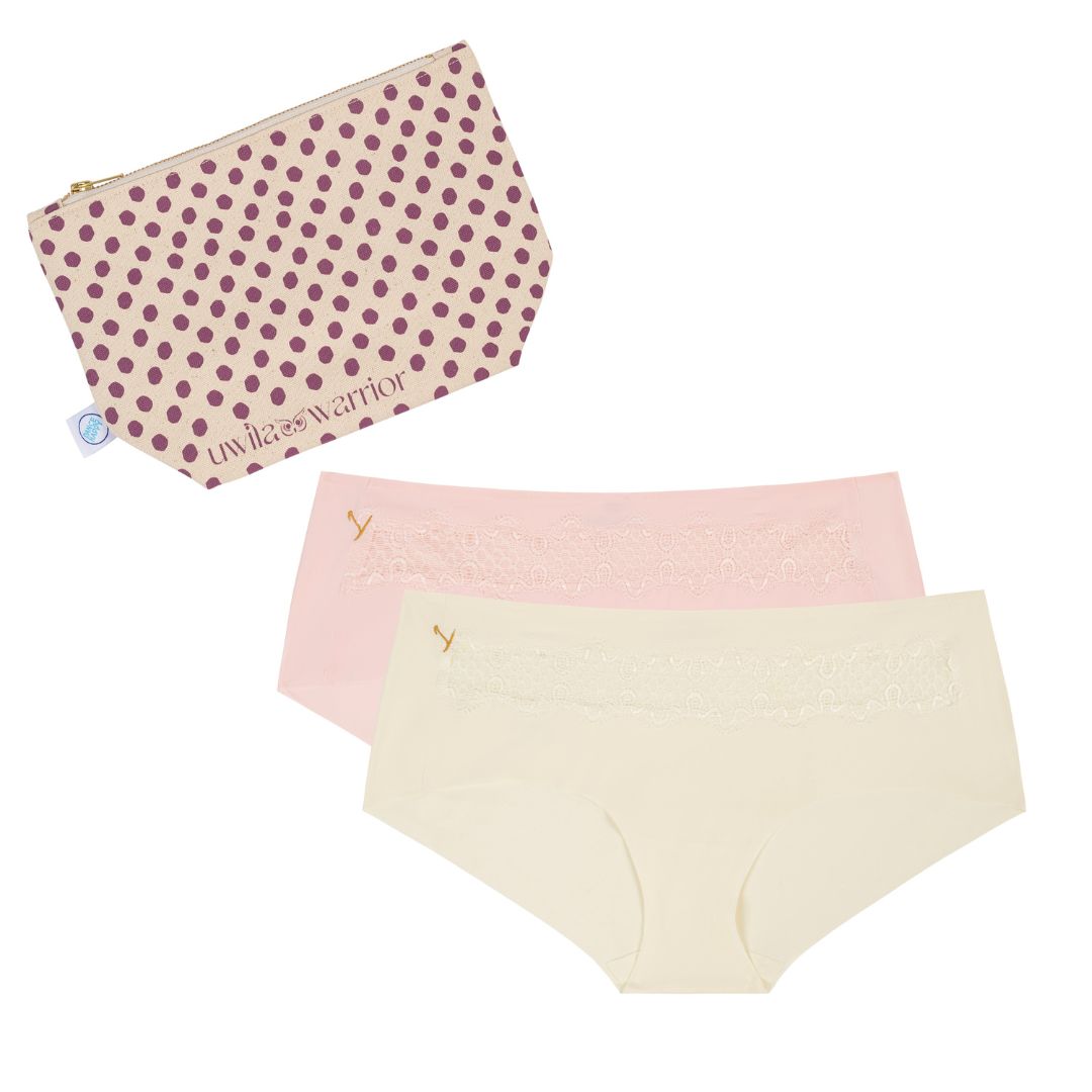A set of women's underwear briefs in rose quartz and winter white colors with lace details, accompanied by a dotted canvas cosmetics bag.