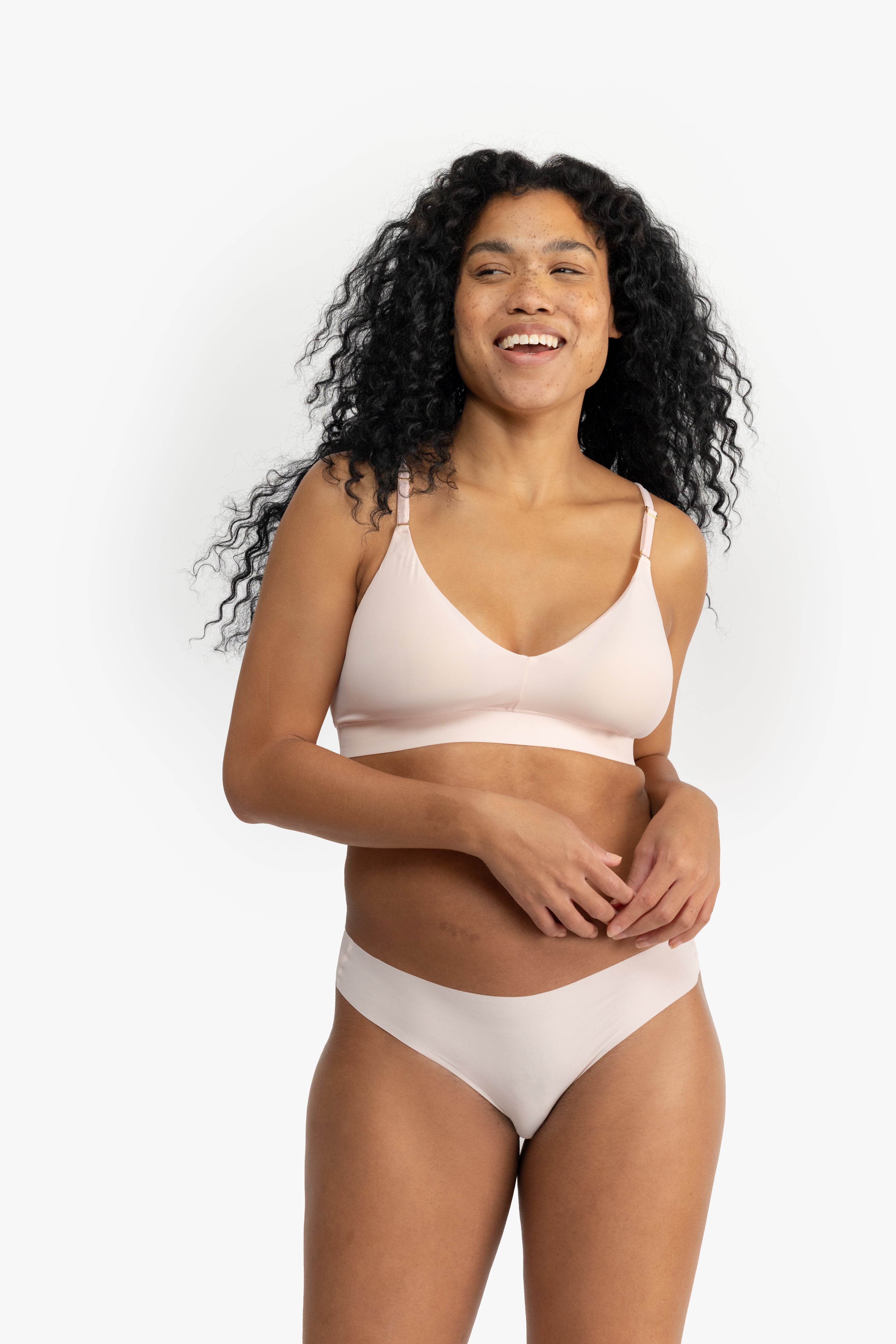 Model wearing Uwila Warrior Better Briefs Soft Bra in Rose Quartz on White Background