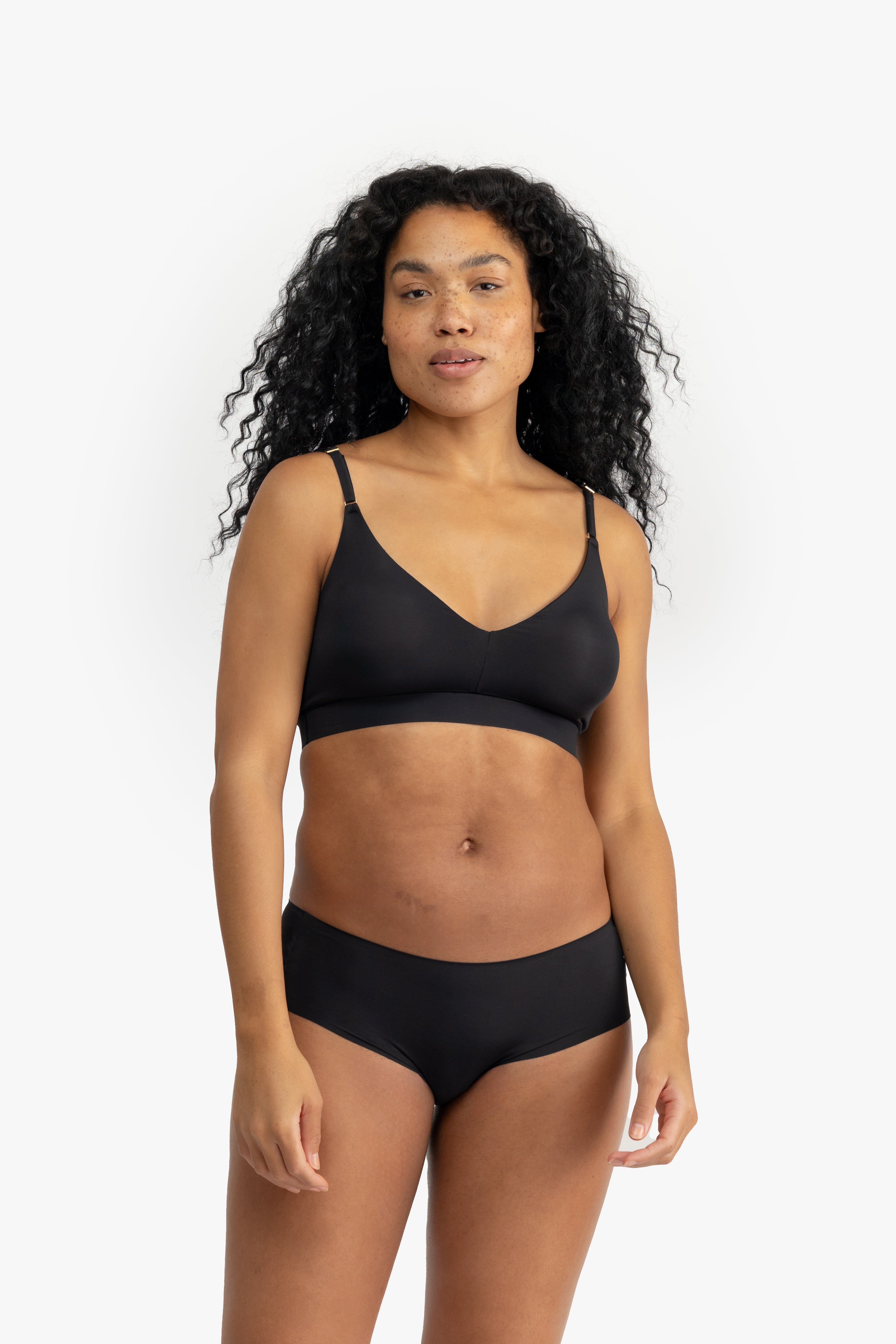 Model wearing Uwila Warrior Better Briefs Soft Bra in Tap Shoe Black on White Background
