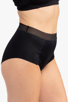 Model Wearing Uwila Warrior HIgh-Waist Silk Briefs Underwear in Tap Shoe Black on White Background